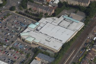 Oblique aerial view of Anniesland shopping centre, looking NNW.