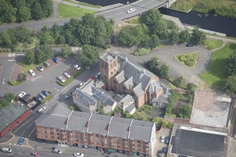 Oblique aerial view of Ruchill Parish Church and Ruchill Parish Church Hall and Janitor's House, looking NNE.