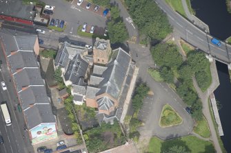 Oblique aerial view of Ruchill Parish Church and Ruchill Parish Church Hall and Janitor's House, looking NNW.