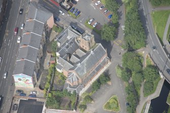 Oblique aerial view of Ruchill Parish Church and Ruchill Parish Church Hall and Janitor's House, looking NW.