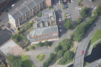 Oblique aerial view of Ruchill Parish Church and Ruchill Parish Church Hall and Janitor's House, looking W.