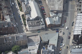 Oblique aerial view of Botanic Garden Garage and Hillhead Salon Cinema, looking SSW.