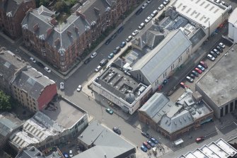 Oblique aerial view of Botanic Garden Garage and Hillhead Salon Cinema, looking SSE.