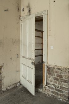 Ground floor, north east room, view of metal door to strong room