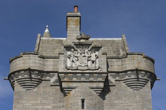 South tower, detail of parapet and coat of arms.