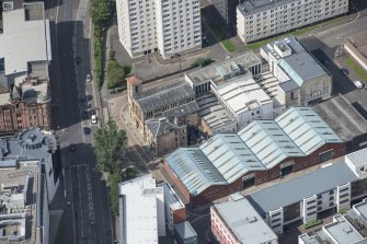 Oblique aerial view of Cowcaddens Free Church and Scottish Ambulance Service, looking NW.