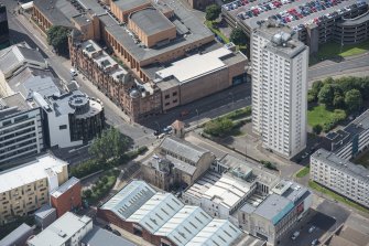 Oblique aerial view of Cowcaddens Free Church and Scottish Ambulance Service, looking SW.