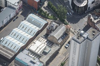 Oblique aerial view of Cowcaddens Free Church and Scottish Ambulance Service, looking SSE.