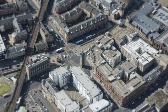 Oblique aerial view of the Trongate Tolbooth Steeple, Mercat Building and Mercat Cross, looking SW.