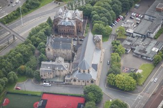 Oblique aerial view of St Mungo's Roman Catholic Church and Martyrs' Public School, looking SE.