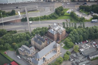 Oblique aerial view of St Mungo's Roman Catholic Church and Martyrs' Public School, looking ESE.