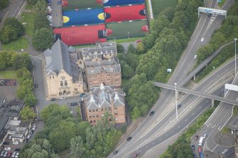 Oblique aerial view of St Mungo's Roman Catholic Church and Martyrs' Public School, looking N.