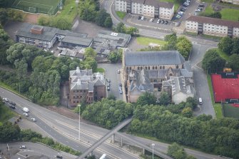 Oblique aerial view of St Mungo's Roman Catholic Church and Martyrs' Public School, looking WSW.