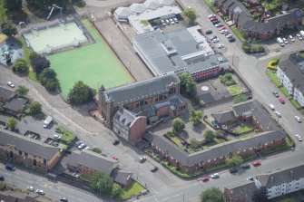 Oblique aerial view of Sacred Heart Church and Presbytery, looking SSW.