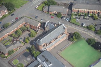 Oblique aerial view of Sacred Heart Church and Presbytery, looking NE.