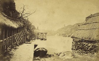 View of Loch Katrine showing pier and thatched cottage