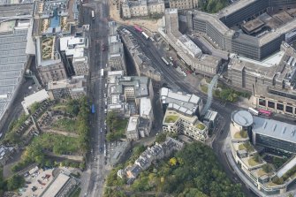 Oblique aerial view of Waterloo Place, Calton Hill Bridge and Leith Street, looking WSW.