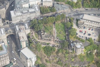Oblique aerial view of Governor's House at St Andrew's House, Regent Bridge and Old Calton Burial Ground, looking N.