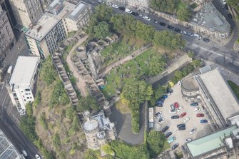 Oblique aerial view of Governor's House at St Andrew's House, Regent Bridge and Old Calton Burial Ground, looking NW.