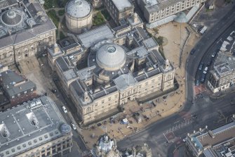 Oblique aerial view of General Register House and the Duke of Wellington Statue, looking NE.