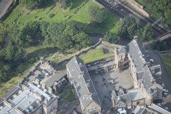 Oblique aerial view of Edinburgh Castle centred on the Butts Battery, looking W.