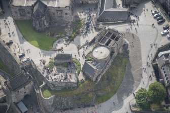Oblique aerial view of Edinburgh Castle centred on St Margaret's Chapel,  looking S.