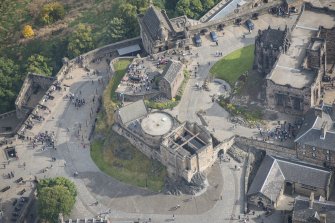 Oblique aerial view of Edinburgh Castle centred on St Margaret's Chapel,  looking ENE.