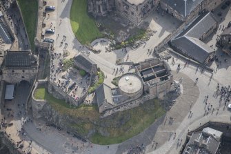 Oblique aerial view of Edinburgh Castle centred on St Margaret's Chapel,  looking E.