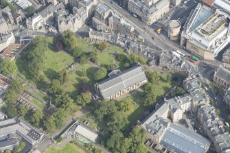Oblique aerial view of Greyfriars Church and Churchyard, Greyfriars Place and Candlemaker Row, looking NE.