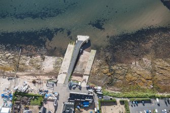 Oblique aerial view of Lamlash Pier, looking SE.