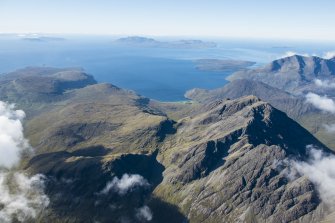 General oblique aerial view of Blabheinn with the Cullin Hills, Loch Scavaig, Soay, Eigg, Rum and Canna beyond, looking SSW.