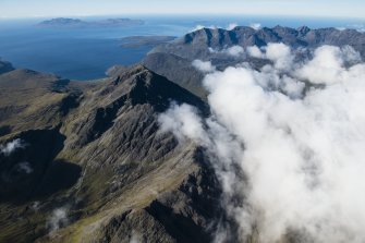 General oblique aerial view of Blabheinn with the Cullin Hills, Loch Scavaig, Soay, Rum and Canna beyond, looking SSW.