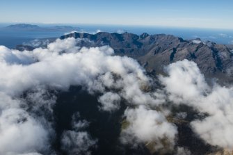 General oblique aerial view of the Cullin Hills with Rum and Canna beyond, looking SW.