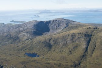General oblique aerial view of Roineabhal with the Sound of Harris, Eabhal, Thacla and Beinn Mhor beyond, looking SSW.