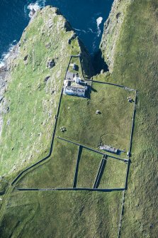 Oblique aerial view of Barra Head Lighthouse, the field boundaries and the possible dun, looking WSW.