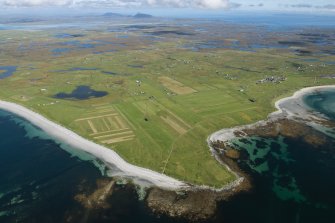 Oblique aerial view of Benbecula and Sidhean Bhuirgh, looking NE.