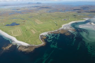 Oblique aerial view of Benbecula and Sidhean Bhuirgh, looking NE.