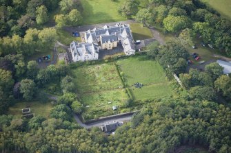 Oblique aerial view of Raasay House and walled garden, looking SSW.
