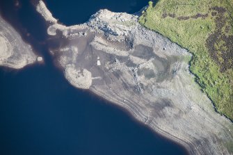 Oblique aerial view of a sheepfold and enclosure in Upper Glendevon Reservoir, looking NE.
