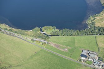 Oblique aerial view Loch Leven sluice and piers, looking NNW.