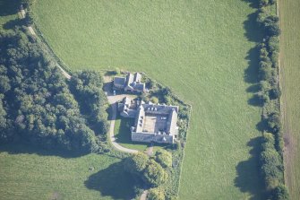 Oblique aerial view of Altyre House Stables, looking E.