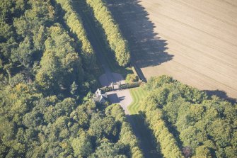 Oblique aerial view of Darnaway Castle West Gate and Lodge, looking NW.