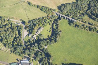 Oblique aerial view of Divie Railway Viaduct and Edinkillie House, looking ENE.
