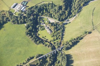 Oblique aerial view of Divie Railway Viaduct and Edinkillie House, looking NW.