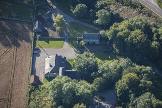 Oblique aerial view of Garlogie Mills Museum of Power and cottages, looking SSE.