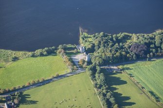 Oblique aerial view of Dunecht House Tower lodges, gates and boathouse, looking SW.