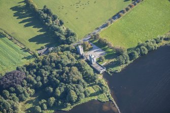 Oblique aerial view of Dunecht House Tower lodges, gates and boathouse, looking ENE.