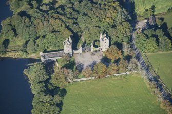 Oblique aerial view of Dunecht House Tower lodges, gates and boathouse, looking WNW.