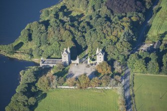 Oblique aerial view of Dunecht House Tower lodges, gates and boathouse, looking W.