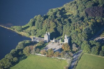 Oblique aerial view of Dunecht House Tower lodges, gates and boathouse, looking WSW.